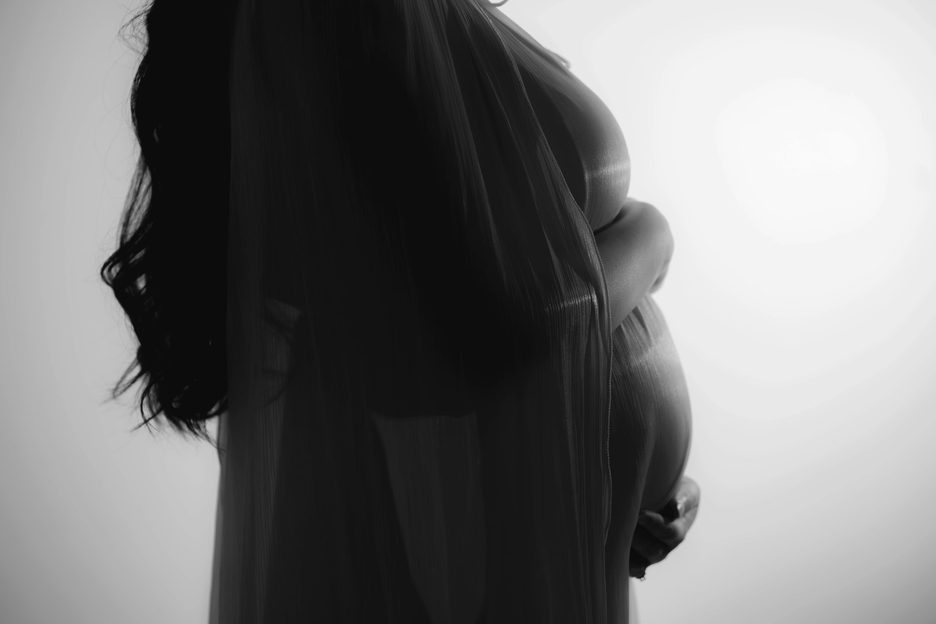 Mother cradling her baby bump